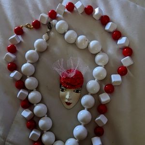 Red and white beads with a beautiful pen